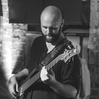 Black and white: a bearded bass player mid-song.