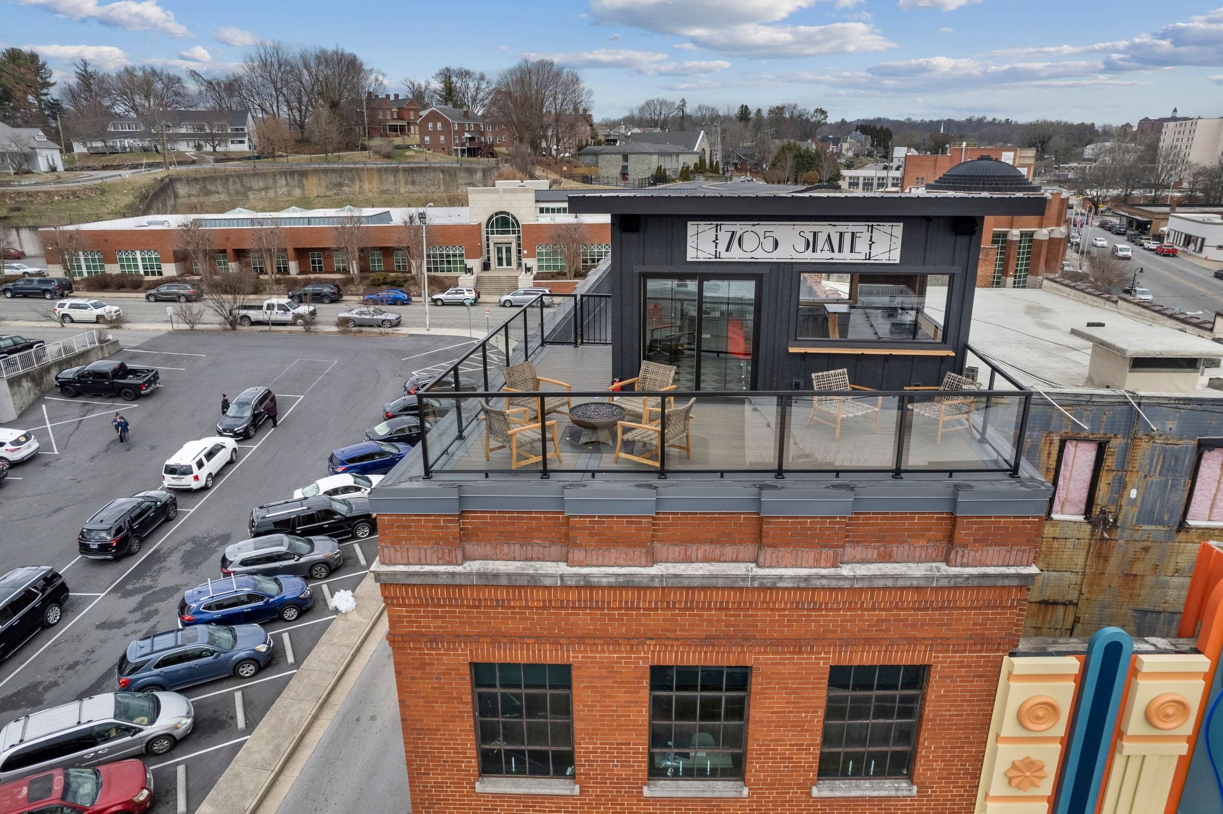 From above: the penthouse's 705 State sign, its glass door and the rooftop deck.