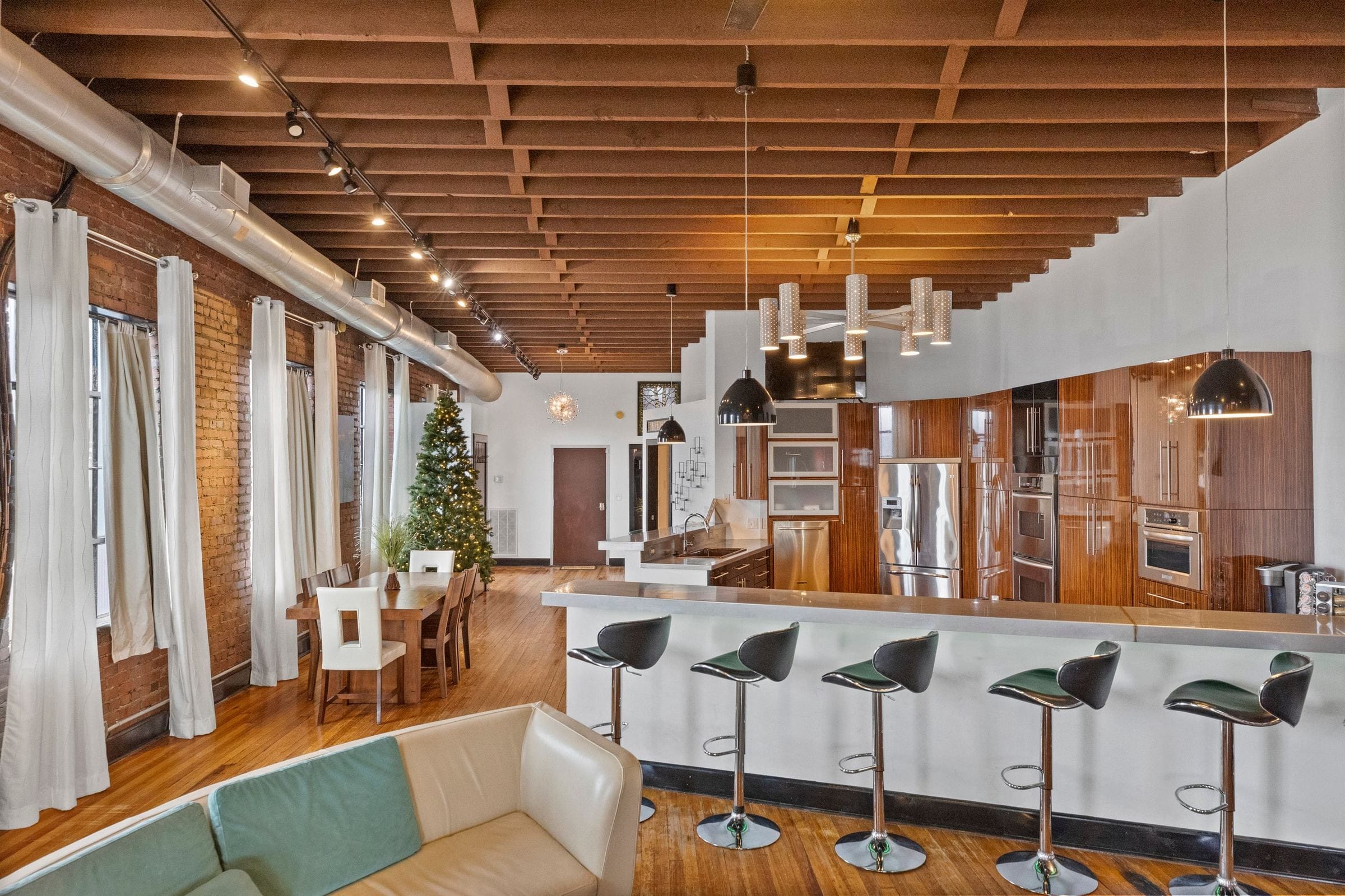 The long kitchen bar and its stools, with the kitchen and dining table beyond.