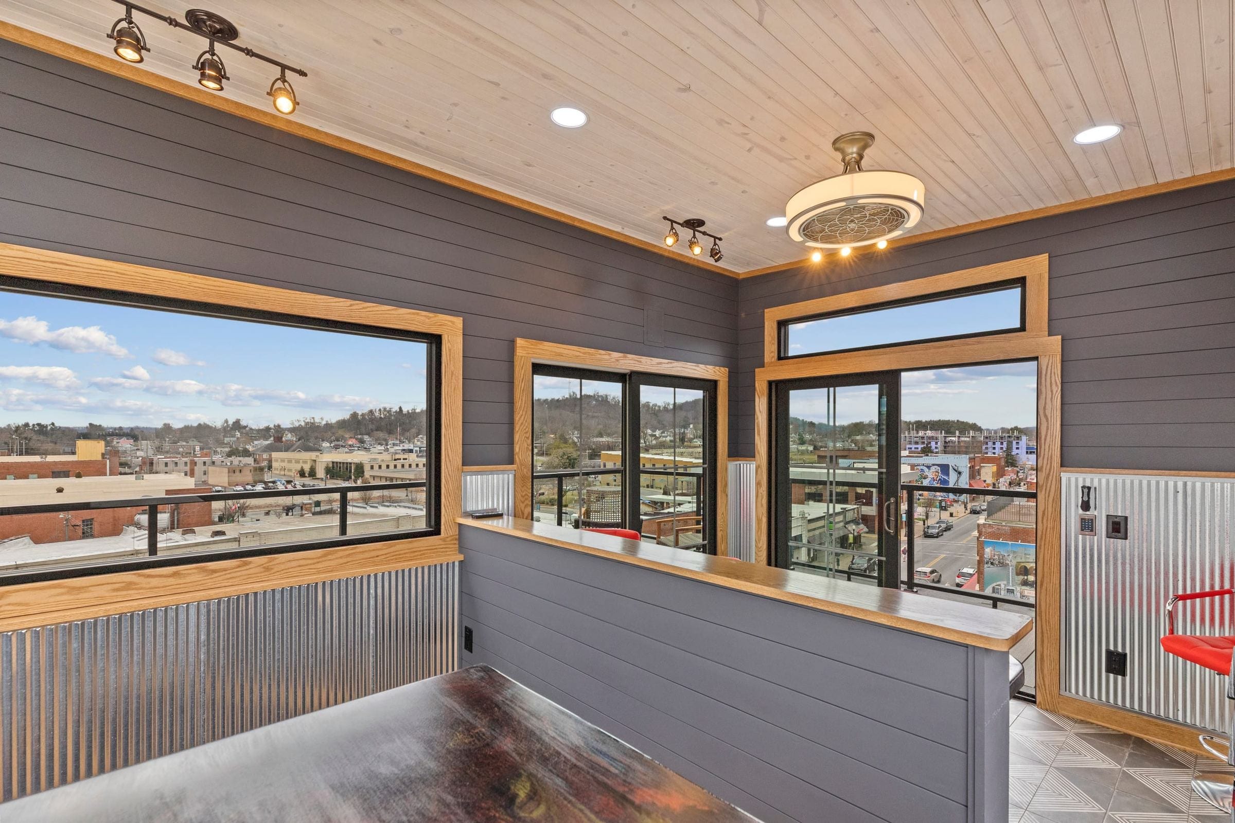Inside the penthouse: wide windows over the rooftops of downtown Bristol.
